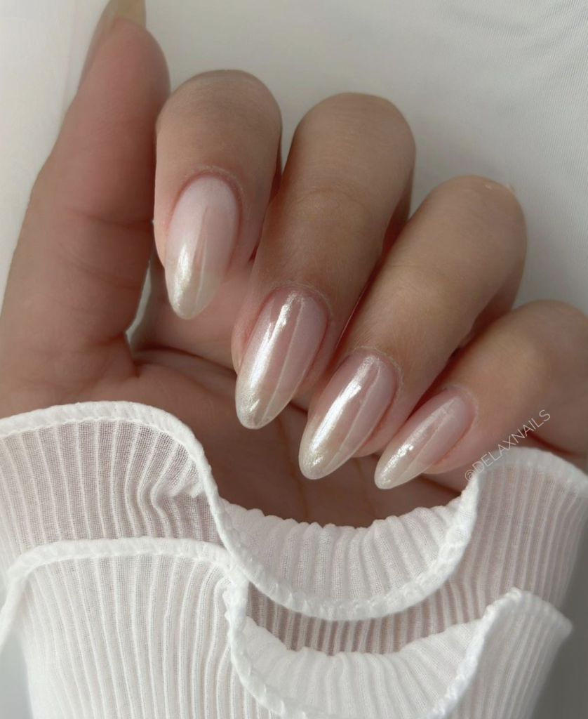 Close-up of nails with a chrome finish on a nude base.